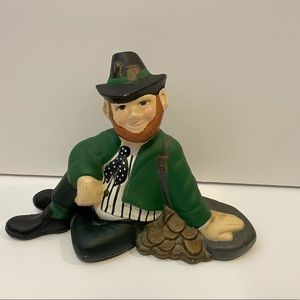 Irish man with bag of gold figurine